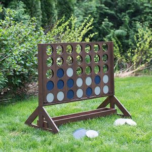 Giant backyard wooden connect four game with white and blue saucer inserts.