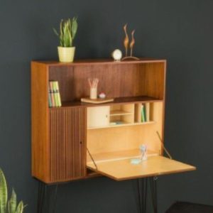 Wooden wall attachment that folds down into a desk.