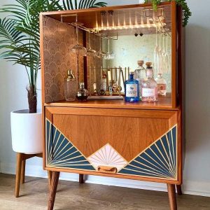 Retro looking cocktail bar with multiple liquors and cocktail glasses on display.
