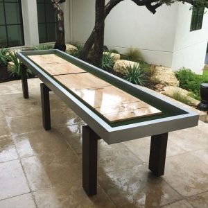 Outdoor shuffleboard table with gray and black trim. 