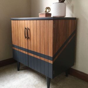 Small wooden bar or credenza with blue paint lines. 