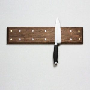 4 inch by 12 inch wooden knife rack with one knife shown connected.