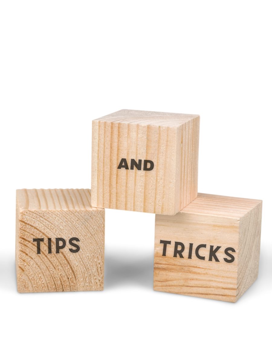 Three wood blocks with "Tips", "Tricks", "and" written on it.